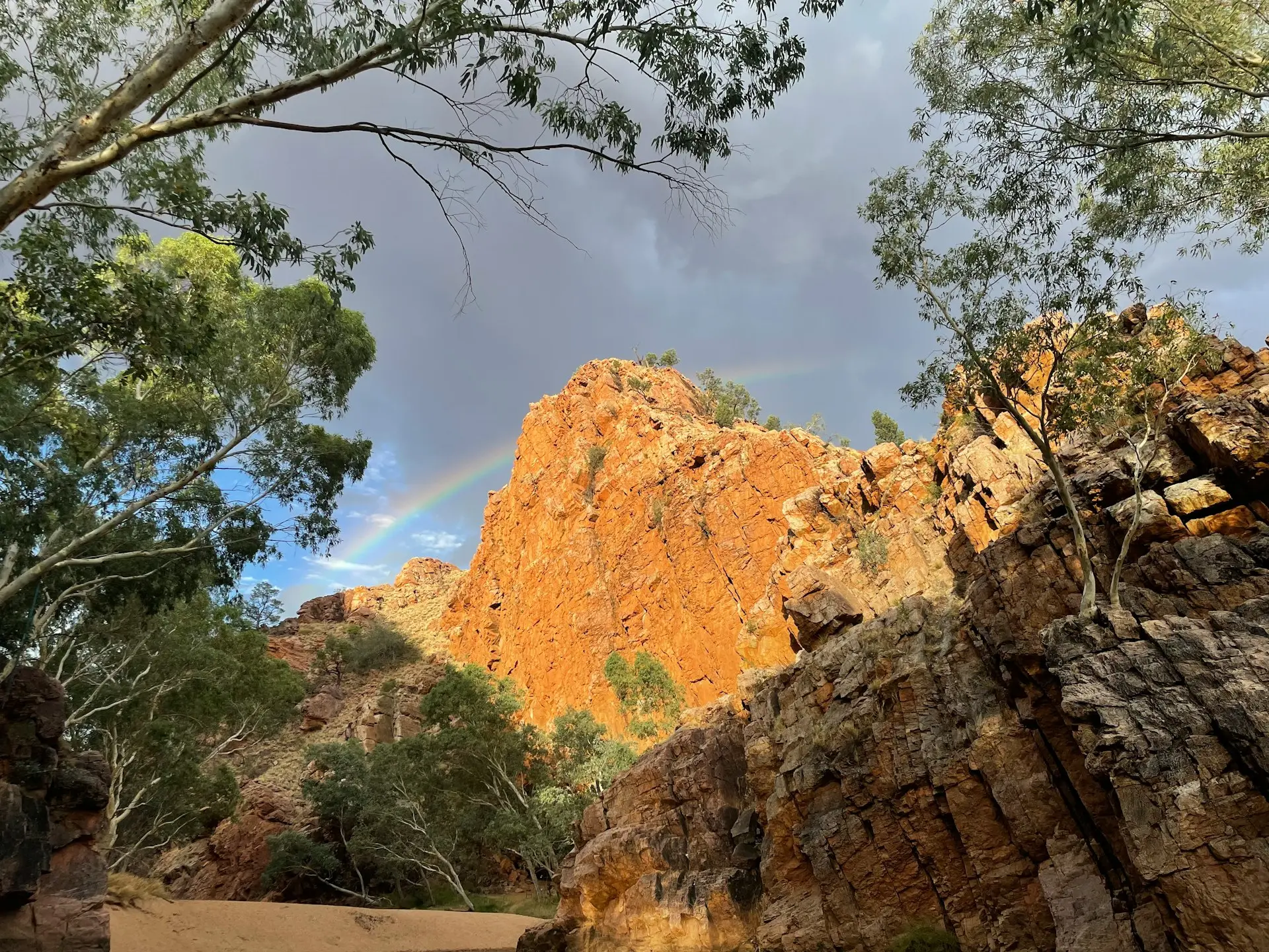 A rainbow in the sky over a mountain range